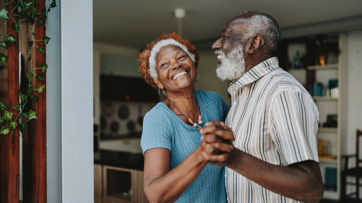 Older couple dancing and smiling together